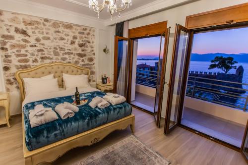 a bedroom with a bed with towels on it at Vip Lepanto Port Suites in Nafpaktos