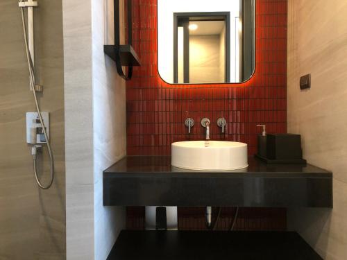 a bathroom with a sink and a mirror at Edge Central Pattaya By Alice in Pattaya