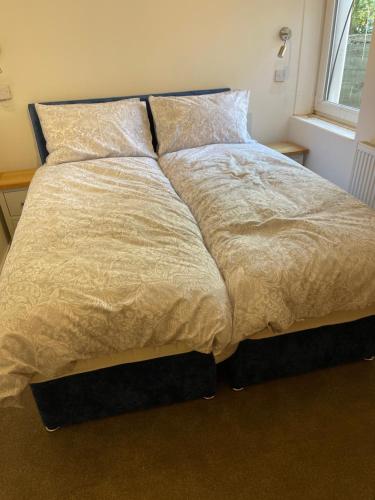 a large bed in a room with a window at Fisherman's Retreat in Wells next the Sea