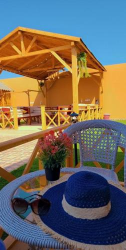 a blue hat sitting on top of a table at شاليه الخفجي in Al Khafji