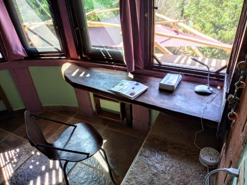 a room with a table and a chair and a window at Posada Olivo in Mazunte