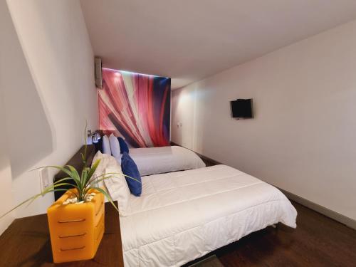 Cama o camas de una habitación en Hotel Austral Suites By GHO Hoteles