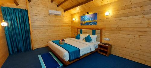 a bedroom with a bed in a wooden room at Parisa beach resort Tarkarli Bhogwe in Malvan