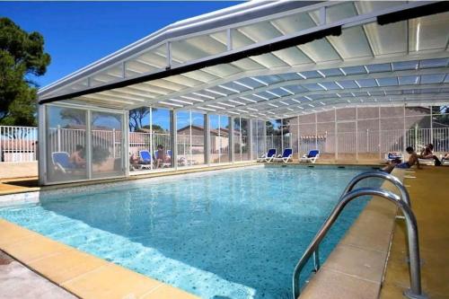 a swimming pool with awning over a swimming pool at Villa L'Occitane in Calvisson