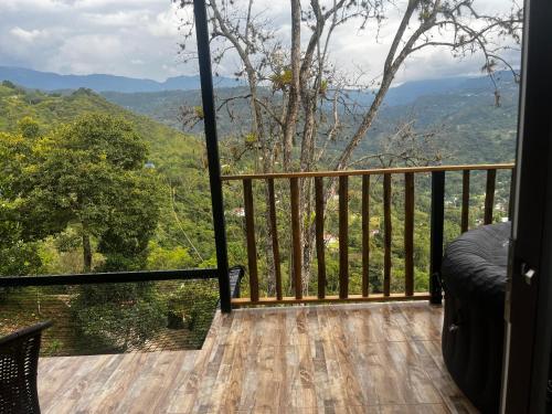 a balcony with a view of the mountains at Glamping Bellavista in La Vega