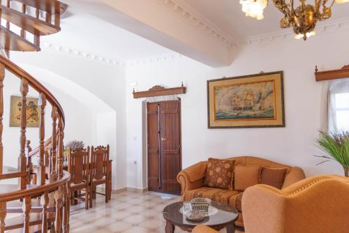 a living room with a couch and a table at Castello di Haria in Kaloú