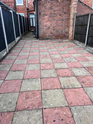 a patio with red and grey bricks and a brick building at Amaya Two - Spacious, ground floor apartment with a large patio area. in Lincolnshire