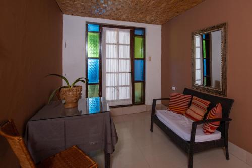 a living room with a couch and stained glass windows at Hotel Pat'ta Hoiri in San Pedro de Atacama