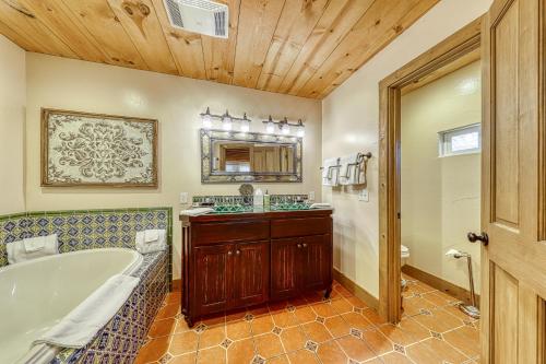 a bathroom with a tub and a sink at The Studio @ Durst Haus in Fredericksburg