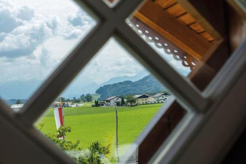 a view from a window of a field and mountains at GIRLINGGUT Schlafen Starten Salzburg in Elixhausen