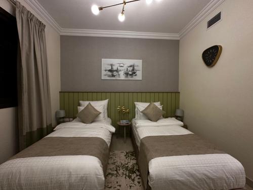 Кровать или кровати в номере GOODWOOD SUITES HOMES VACATION