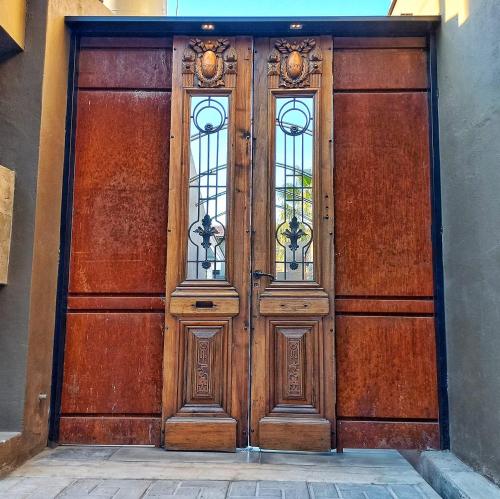 a large wooden door with windows on a building at H125 - Complejo Mendoza in Mendoza