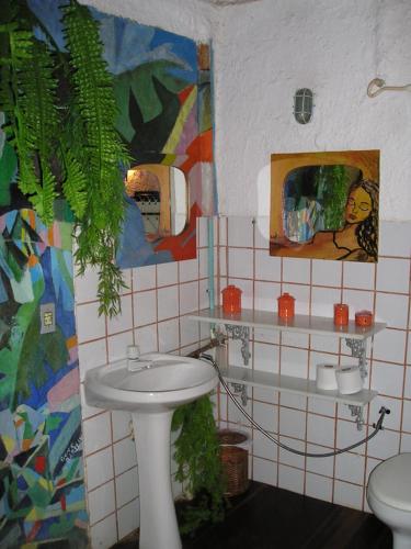 a bathroom with a sink and a mirror at Chez Marine Guest House in Búzios