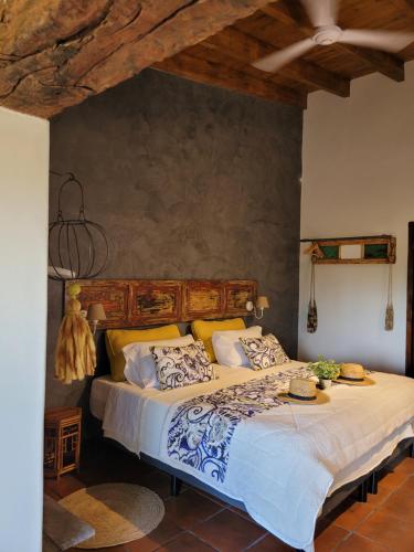 a bedroom with a large bed in a room at Finca La Saucina Casa de Campo in Tunuyán