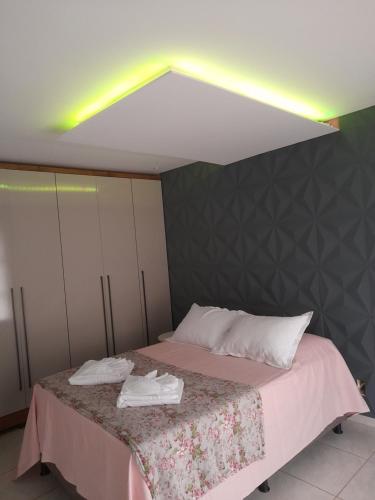 a bedroom with a bed with two towels on it at LUZ DO LUAR in Pedra Azul