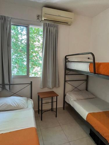 a room with two bunk beds and a window at Reina Madre Hostel in Buenos Aires