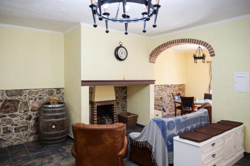 a living room with a fireplace and a chandelier at A Janela do Alentejo in Campinho
