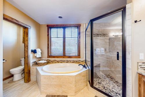 a large bathroom with a tub and a shower at BOTHR Steelhead in McCall