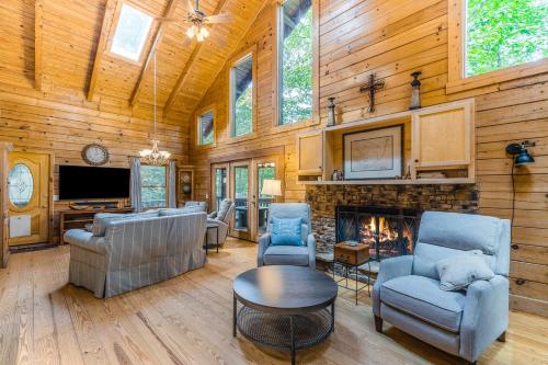 a living room with a fireplace in a wooden house at Nana's Nest in Blue Ridge