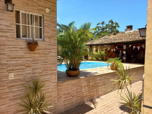 two pictures of a house with a swimming pool at Nino's in Niterói