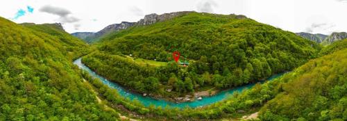 an aerial view of a mountain with a river at Grab cabin in Pluzine