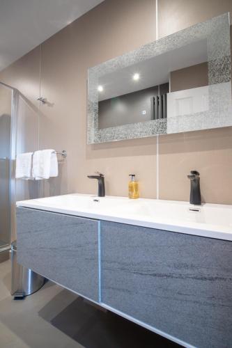 a bathroom with a large sink and a mirror at Redcliffe Hotel in Inverness