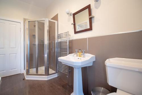 a bathroom with a sink and a shower and a toilet at Redcliffe Hotel in Inverness