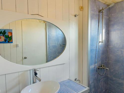 a bathroom with a sink and a mirror and a shower at Blue in José Ignacio