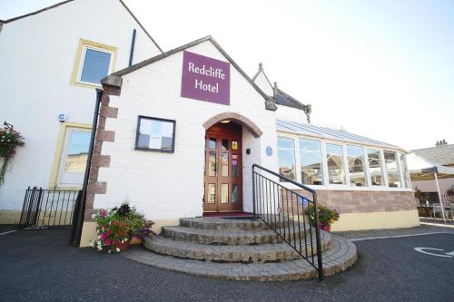 a building with a sign that reads healing hotel at Redcliffe Hotel in Inverness