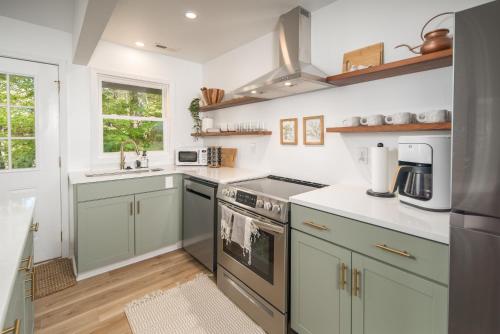 a kitchen with a sink and a stove top oven at The Wanderer Guesthouse in Boone
