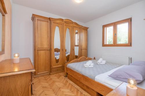 a bedroom with a bed and a wooden cabinet at Holiday House Tone, Imotski-Drum-Makarska in Drum