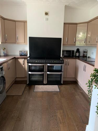 a large kitchen with a stove top oven at Merseybeat Short stays in Birkenhead