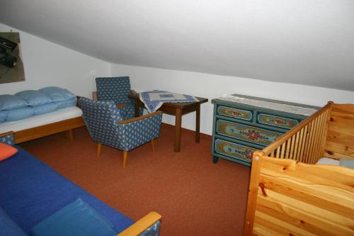 a bedroom with a bed and a table and chairs at Gästehaus Obertanner in Reit im Winkl