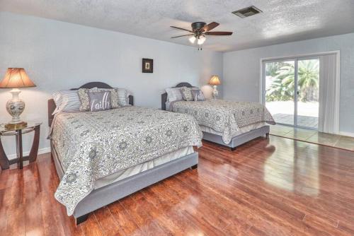 a bedroom with two beds and a ceiling fan at Large Groups Up to 12 Guests In ground POOL in Tampa