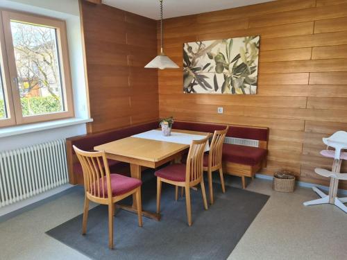 a dining room with a wooden table and chairs at Haus Renate in Wolfurt
