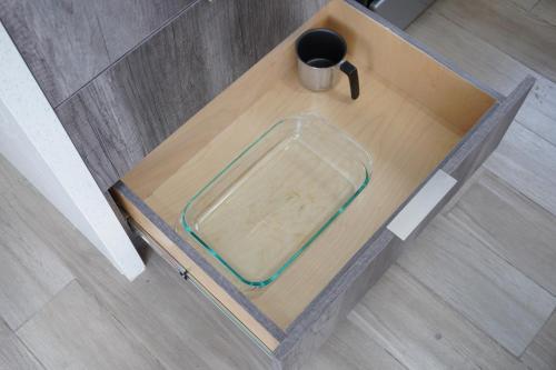 a wooden table with a glass plate on top of it at Milan San Marino in Tijuana