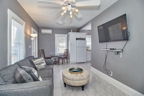 a living room with a couch and a flat screen tv at Gorgeous Loft Apartment Centrally Located Tampa in Tampa