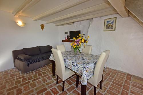 a dining room with a table and a couch at Villa Fragola in Motovun