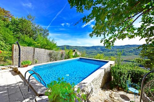a swimming pool with a view of the mountains at Villa Fragola in Motovun