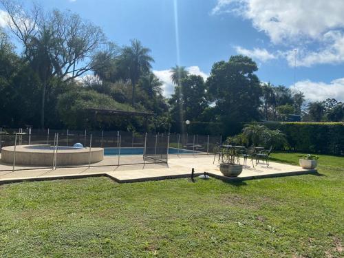 a park with a pool with chairs and a table at casa-quinta cerca de corrientes y santa ana in Corrientes