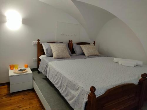 a bedroom with a large bed and a night stand at Il cielo di Raffaello in Urbino