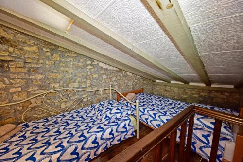 a bedroom with a bed and a stone wall at Villa Luna in Motovun