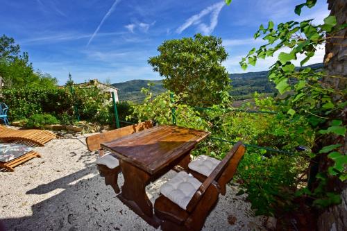 a wooden table and chairs with a view of mountains at Villa Luna in Motovun
