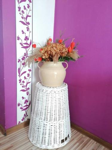 a white vase sitting on top of a white stand at Apartmán blízko centra v Martine in Martin