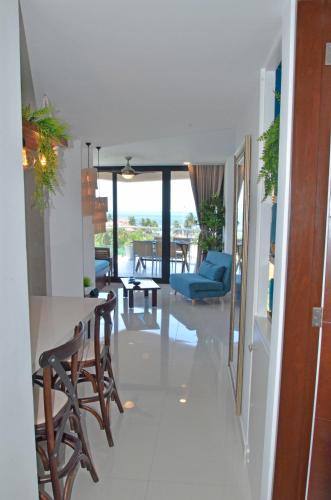 a living room with a table and chairs at TAKH Sea View Apartment in Cancún