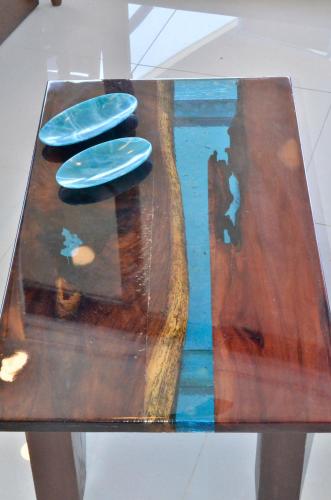a wooden table with three plates on top of it at TAKH Sea View Apartment in Cancún