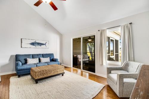 a living room with a blue couch and a chair at Shelter Cove 1722 in Seabrook Island