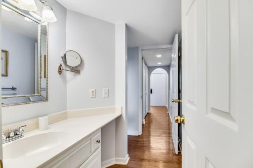 a white bathroom with a sink and a mirror at Shelter Cove 1722 in Seabrook Island