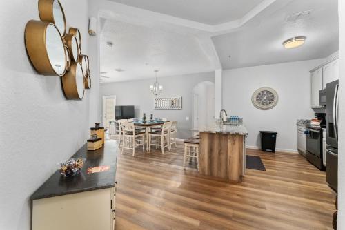 a kitchen and living room with a table and a kitchen and a dining room at Vista Cay Resort in Orlando