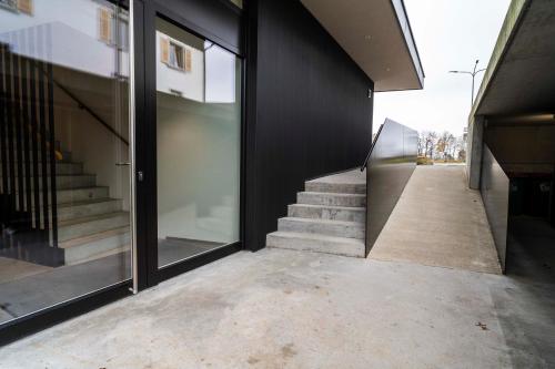 a hallway of a building with glass doors and stairs at Zweite Heimat in Lochau